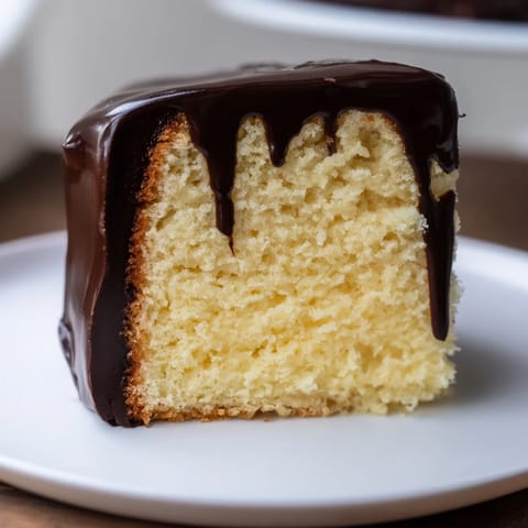 A slice of Ho Ho Cake showcases the layers of cake, fluffy filling, and rich chocolate topping.