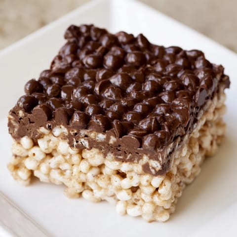 Warm, gooey Rice Krispie Treats, cut into perfect squares, ready to enjoy as a sweet treat.