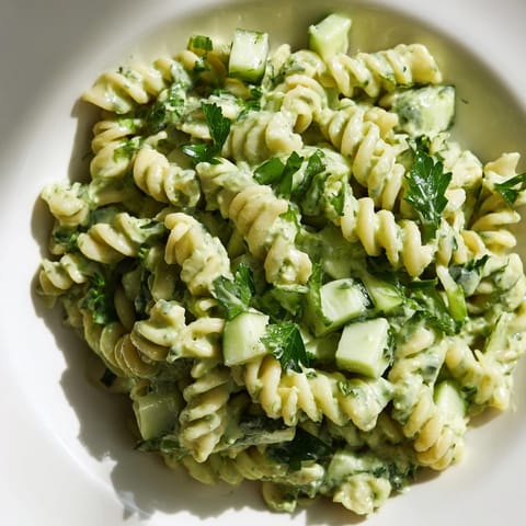 A bowl of Green Goddess Pasta Salad featuring al dente fusilli and vibrant spinach, ready for a light lunch.