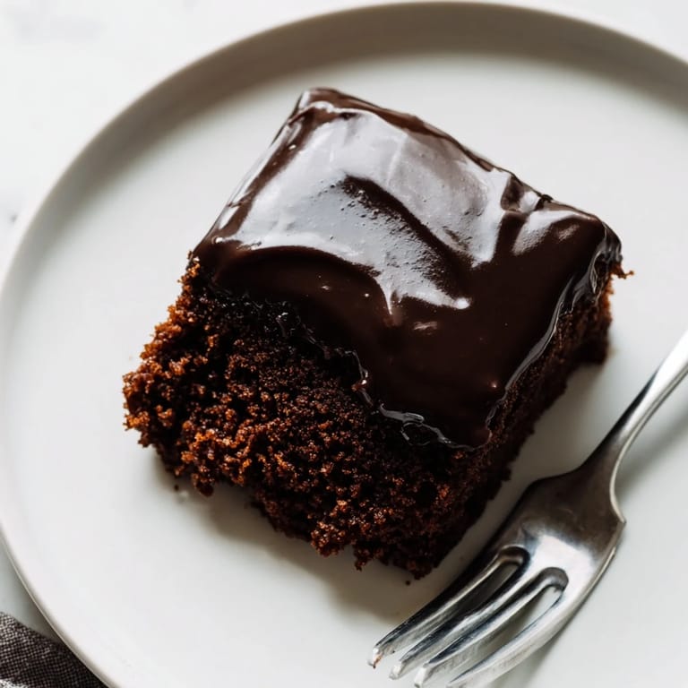 This Texas sheet cake shows off a moist chocolate cake base smothered in decadent, flowing icing.