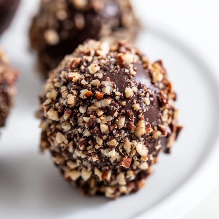 A close-up of delicious Chocolate Truffles, some dusted with cocoa, perfect for a decadent dessert or special occasion.