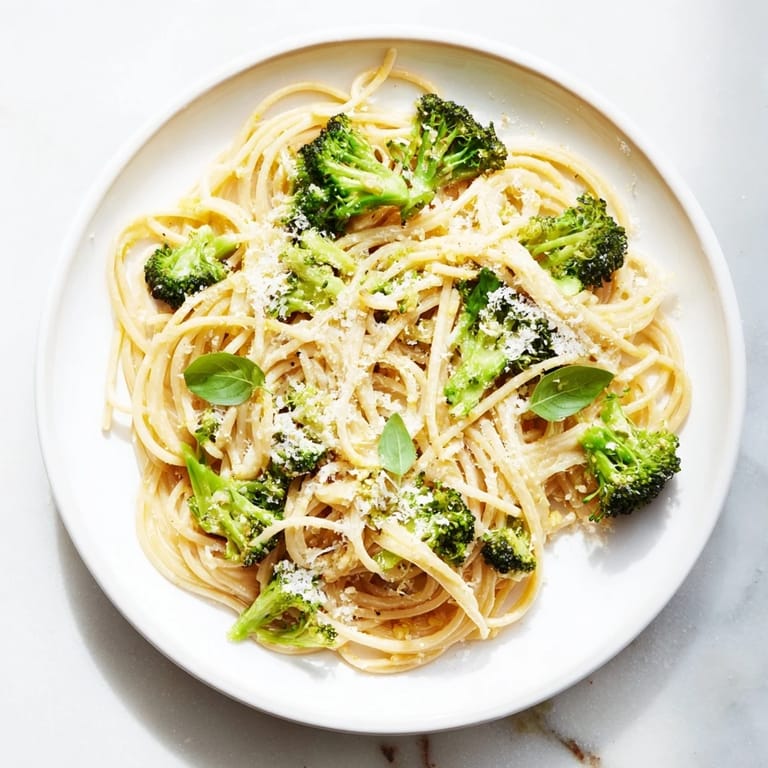 Close-up of One-Pot Lemon Broccoli Pasta, highlighting zesty lemon zest and a garnish of fresh parsley.